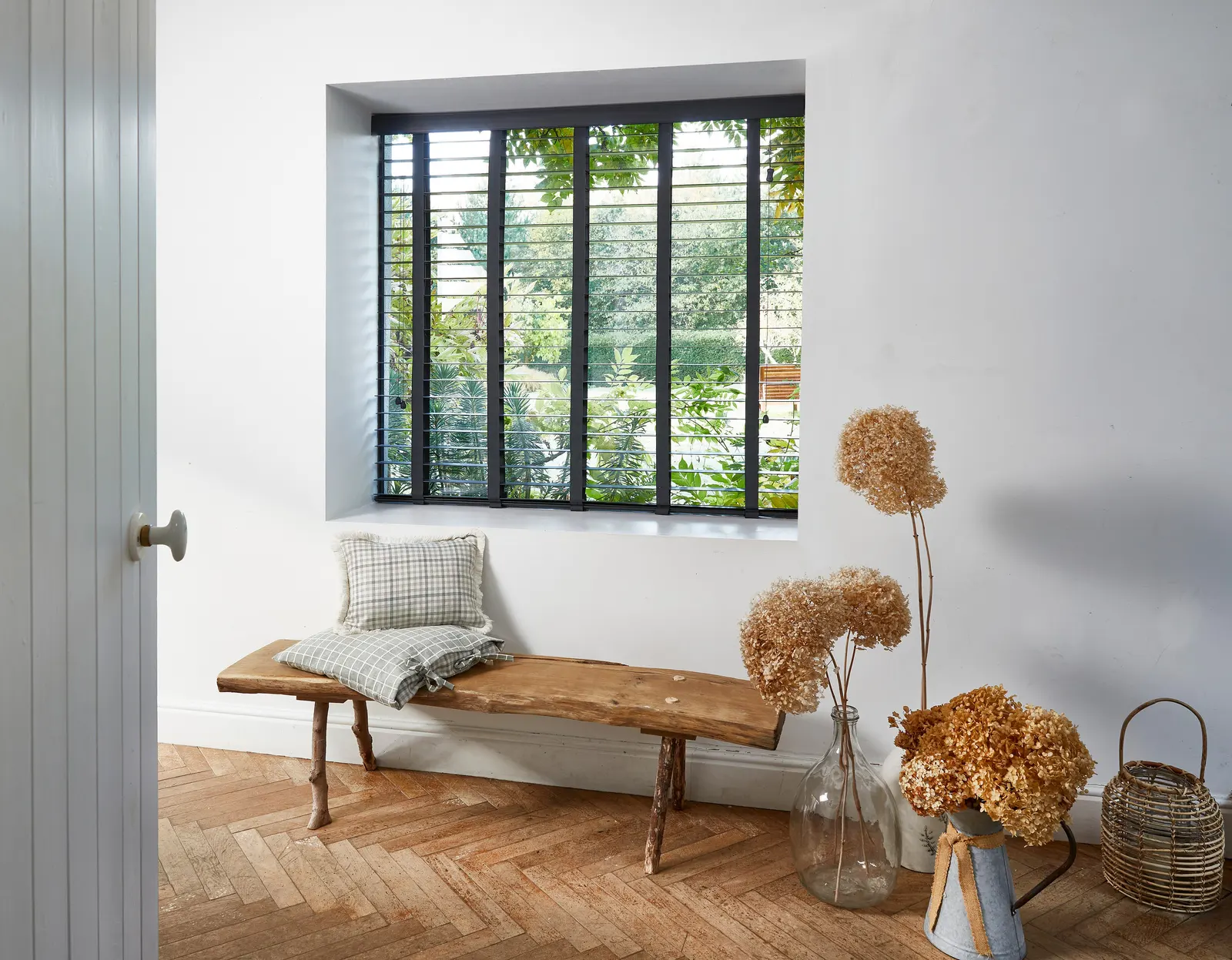 Black wooden slat blinds above a timber bench seat – Harborne Blinds